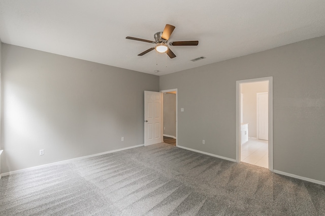 empty room with ceiling fan and light colored carpet