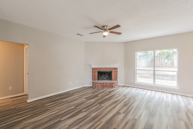 unfurnished living room featuring a brick fireplace, ceiling fan, and hardwood / wood-style flooring