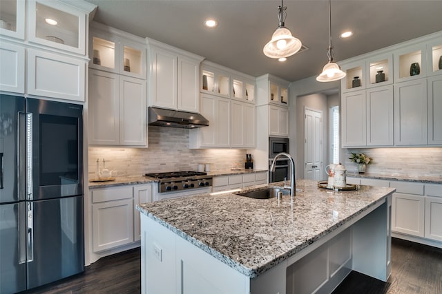 kitchen featuring tasteful backsplash, sink, stainless steel appliances, and dark wood-type flooring