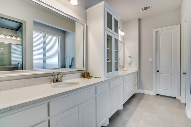 bathroom featuring dual bowl vanity and tile patterned floors