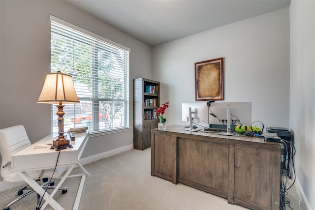 office space featuring light carpet and plenty of natural light