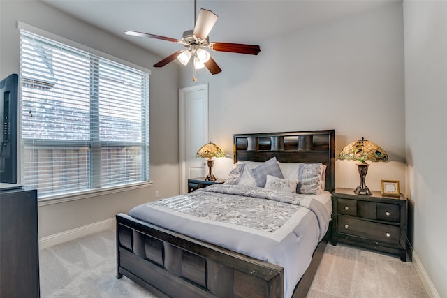 bedroom featuring ceiling fan and light carpet