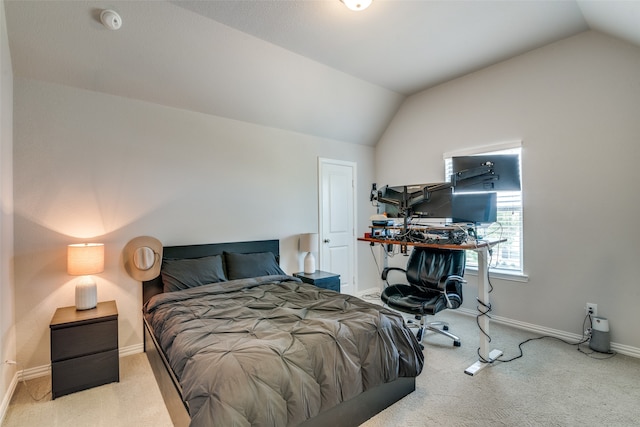 bedroom featuring vaulted ceiling and light colored carpet