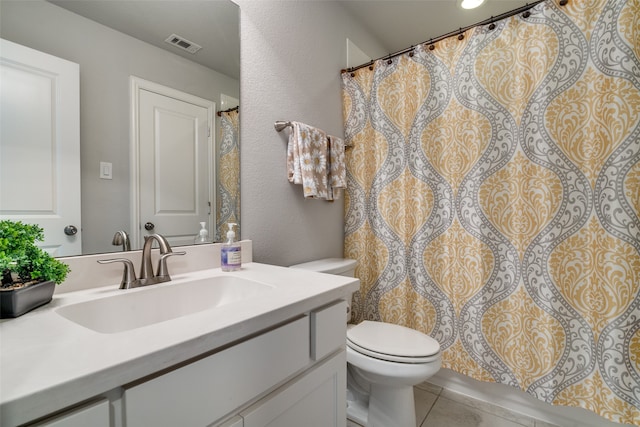 bathroom featuring tile patterned floors, vanity, and toilet