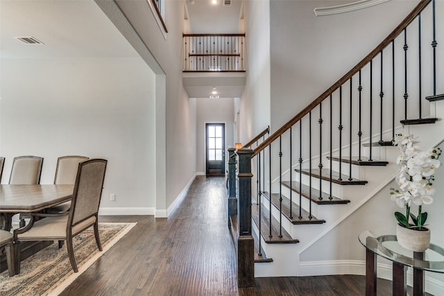 entrance foyer with wood-type flooring and a high ceiling