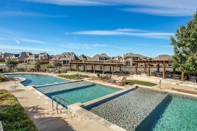 view of swimming pool featuring a patio and a pergola