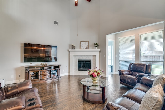 living room featuring ceiling fan and dark wood-type flooring