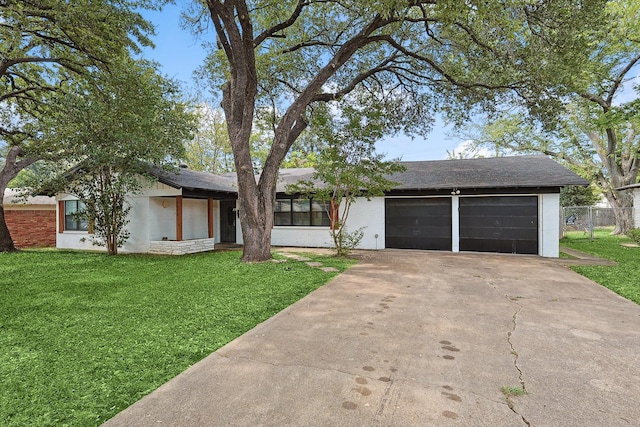 single story home featuring a garage and a front lawn