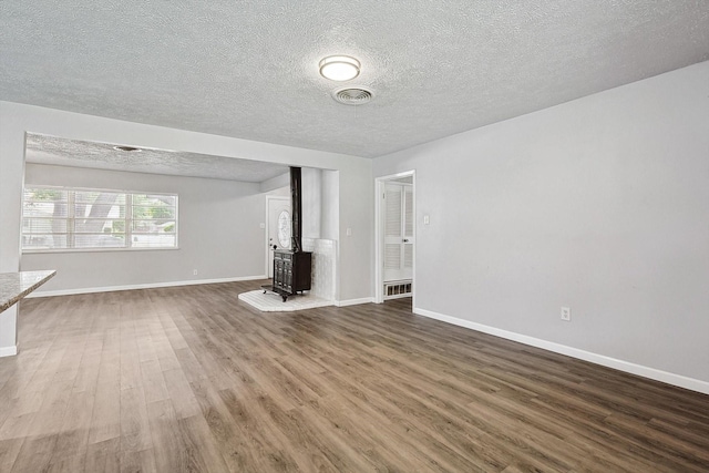 2120 Nottingham Blvd, Fort Worth, TX 76112 - unfurnished living room with hardwood / wood-style flooring and a textured ceiling