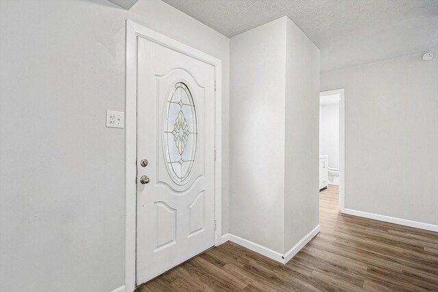 2120 Nottingham Blvd, Fort Worth, TX 76112 - entrance foyer featuring hardwood / wood-style floors and a textured ceiling
