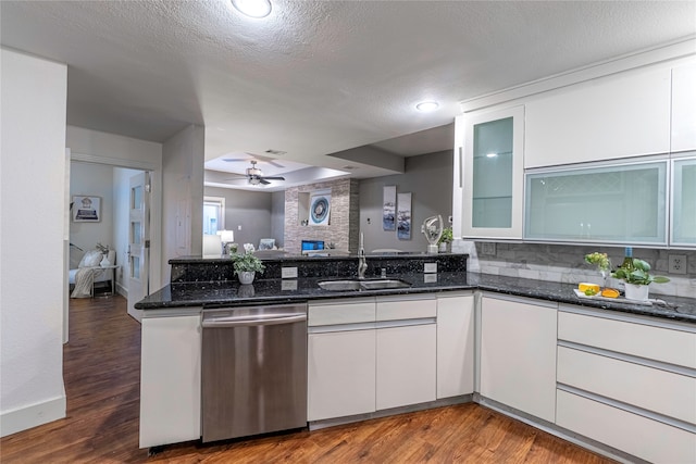 kitchen with dishwasher, a textured ceiling, dark hardwood / wood-style floors, white cabinetry, and ceiling fan