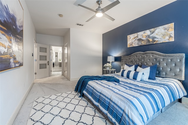 carpeted bedroom with ceiling fan and ensuite bathroom