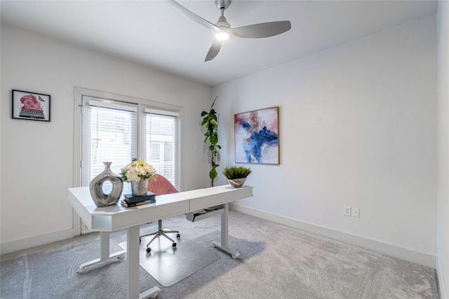 carpeted home office featuring ceiling fan