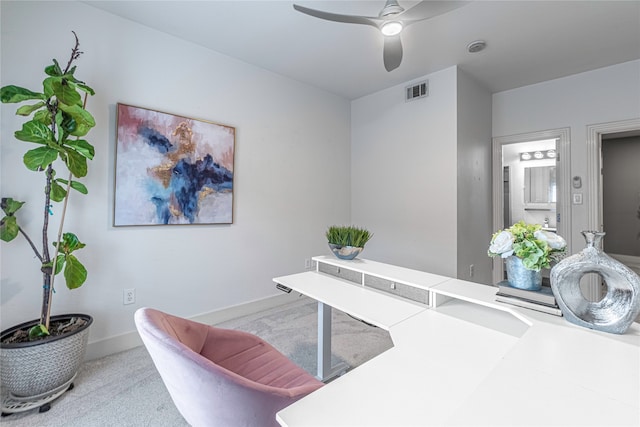 office space with ceiling fan and light carpet