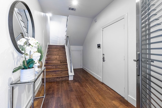 entryway featuring lofted ceiling and dark hardwood / wood-style flooring