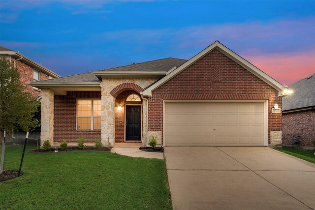 view of front facade with a garage and a yard