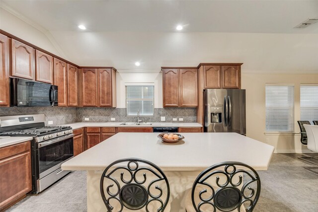 kitchen featuring black appliances, sink, light tile patterned floors, and crown molding