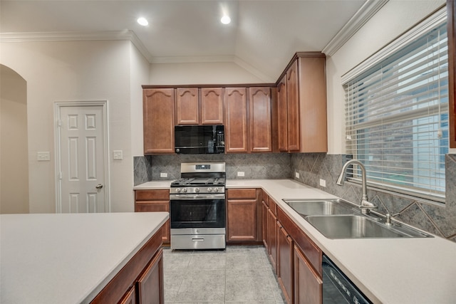 kitchen featuring lofted ceiling, backsplash, light tile patterned floors, sink, and stainless steel gas range oven