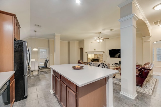 kitchen with ornate columns, hanging light fixtures, stainless steel fridge, ceiling fan, and a fireplace