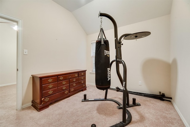 workout room featuring light carpet and vaulted ceiling