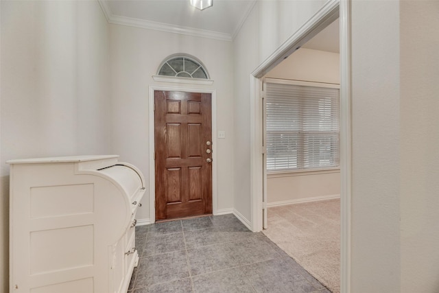 carpeted foyer entrance with ornamental molding