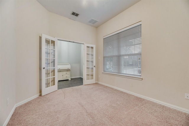 unfurnished bedroom featuring carpet floors and french doors