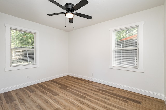 spare room with ceiling fan and wood-type flooring