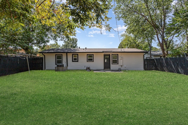 rear view of house with a patio and a lawn