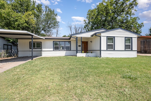 ranch-style home with a front yard and a carport