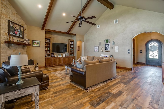 living room featuring built in shelves, hardwood / wood-style floors, high vaulted ceiling, ceiling fan, and beam ceiling