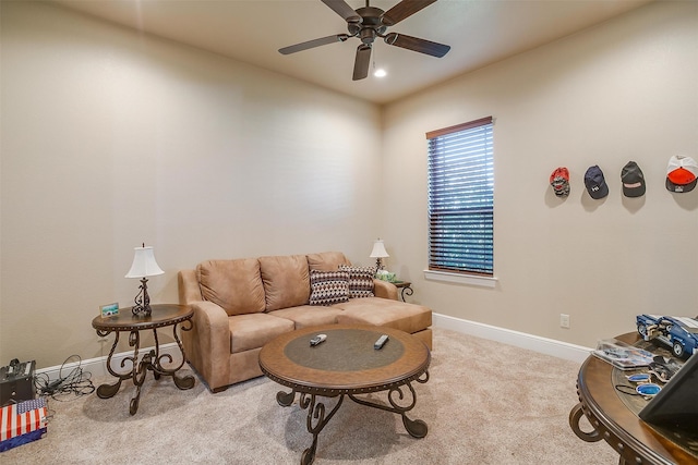 carpeted living room featuring ceiling fan