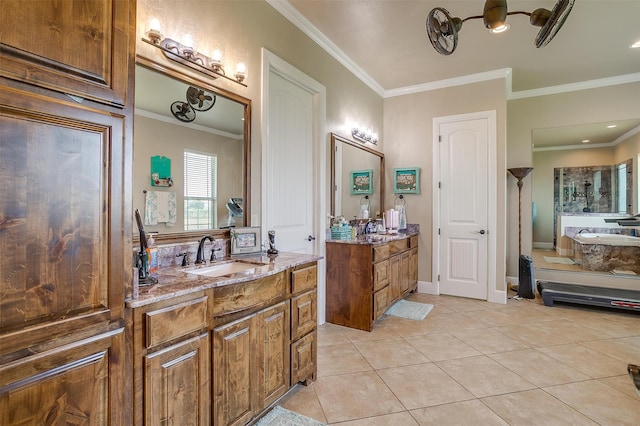 bathroom with tile patterned floors, double sink vanity, ornamental molding, and a washtub