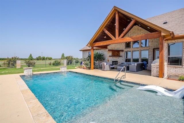 view of swimming pool featuring a lawn, a patio, an outdoor living space, and pool water feature