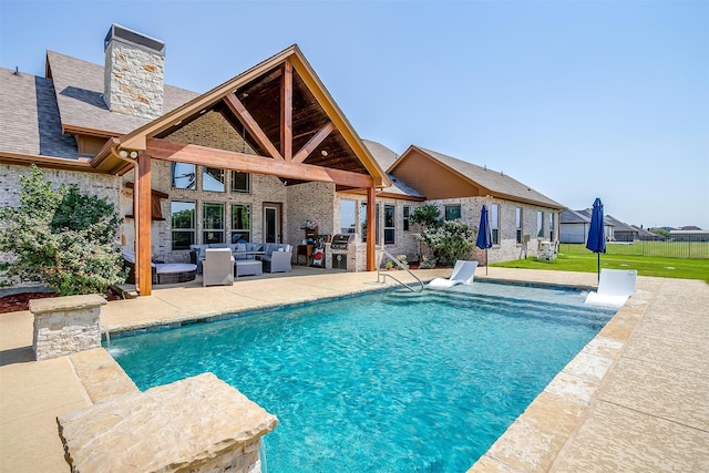 view of pool featuring a patio, pool water feature, an outdoor living space, and a yard