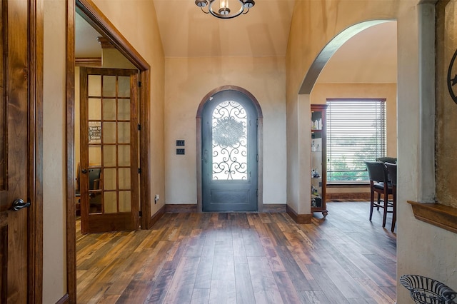 entryway with lofted ceiling and wood-type flooring