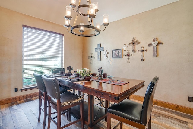 dining room featuring a notable chandelier and wood-type flooring