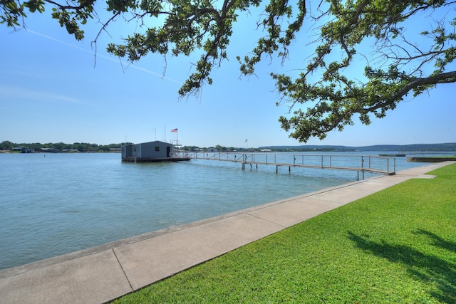 dock area featuring a water view and a yard