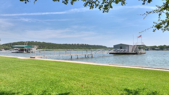 dock area featuring a water view and a yard