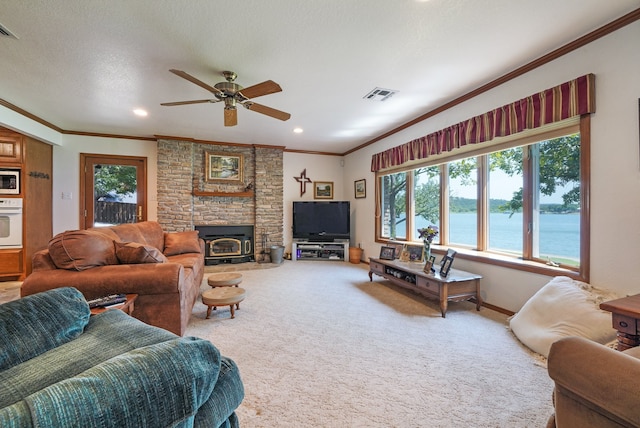 carpeted living room with ceiling fan, crown molding, and a textured ceiling