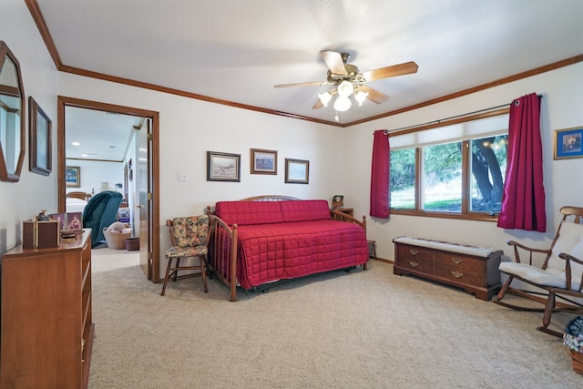 carpeted bedroom with ornamental molding and ceiling fan