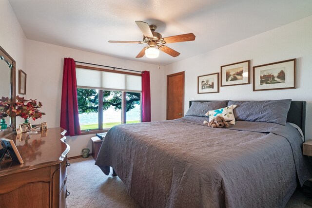 carpeted bedroom with ceiling fan