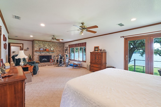 bedroom featuring ceiling fan, access to exterior, ornamental molding, light carpet, and a stone fireplace