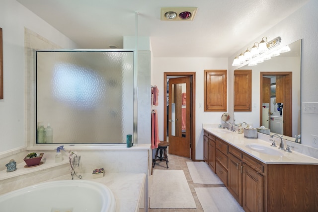 bathroom featuring vanity and shower with separate bathtub