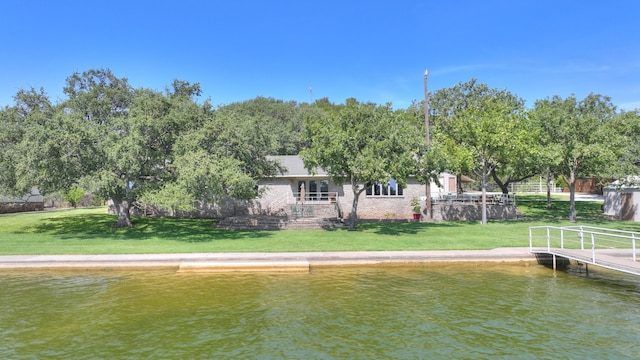 dock area featuring a water view and a yard