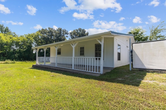 exterior space with a lawn and a porch