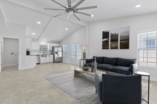 living area featuring vaulted ceiling with beams, ceiling fan, recessed lighting, baseboards, and french doors