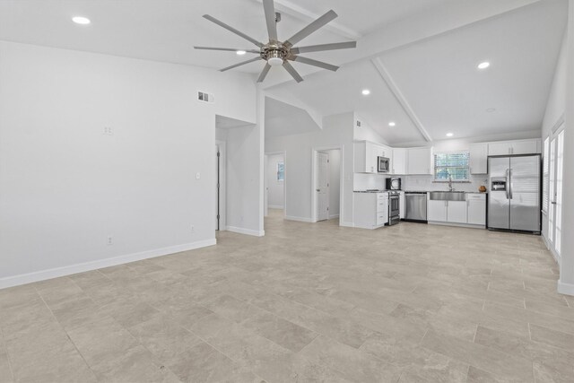 unfurnished living room featuring baseboards, visible vents, lofted ceiling with beams, ceiling fan, and a sink