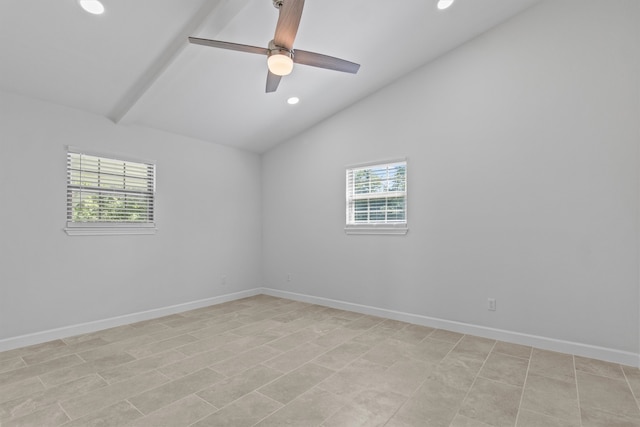 tiled empty room featuring ceiling fan, a wealth of natural light, and vaulted ceiling with beams