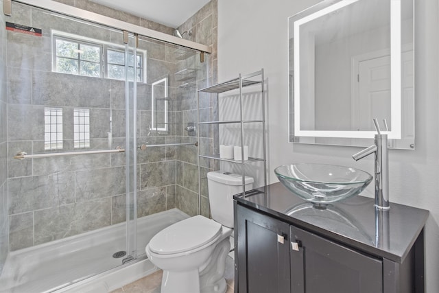 bathroom featuring an enclosed shower, vanity, tile patterned flooring, and toilet