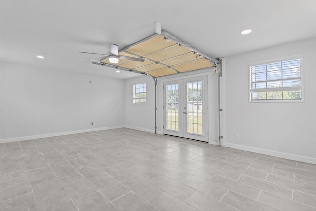 empty room featuring baseboards, french doors, and recessed lighting